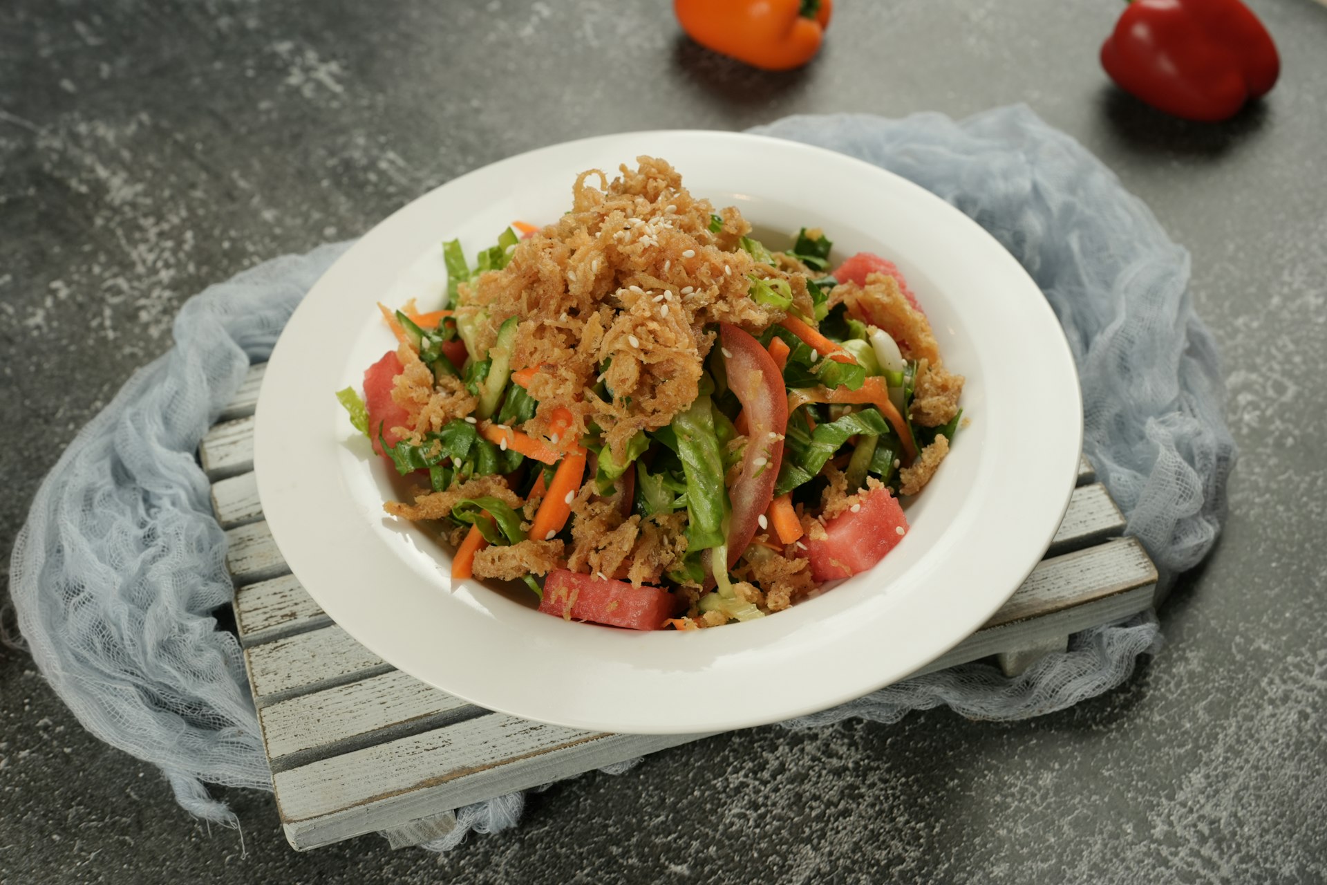 A delicious salad with crispy fried onions.